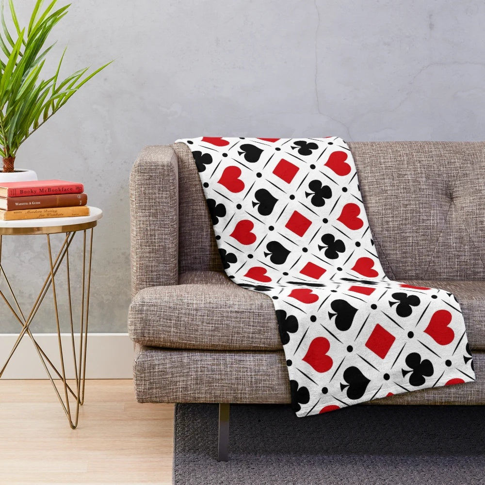 Plush blanket with playing card suits symbols and geometric patterns