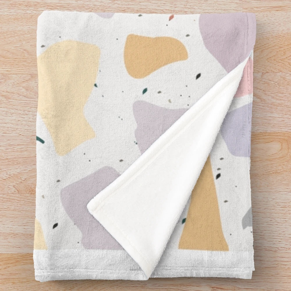 Plush blanket with colorful terrazzo design
