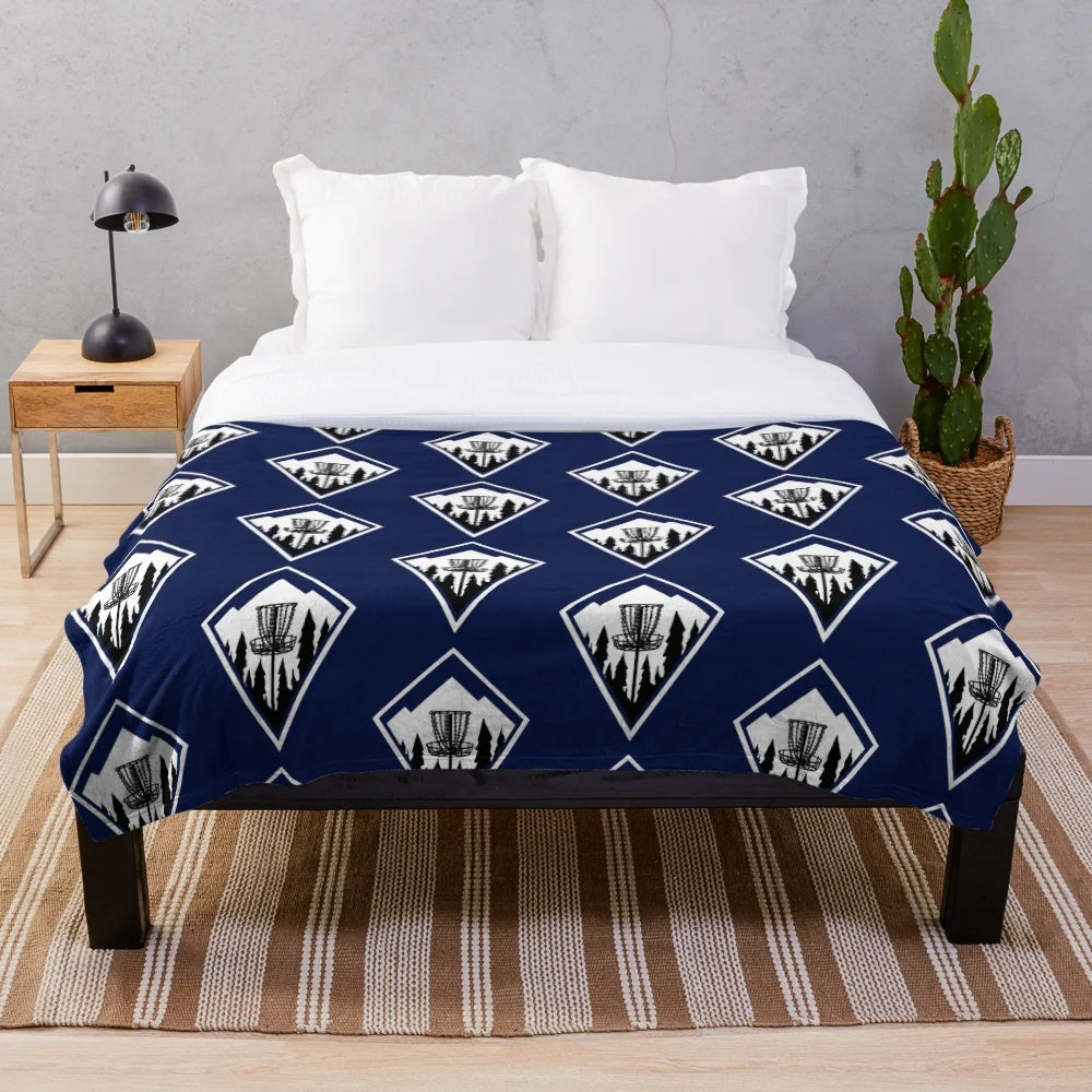 Plush disc golf themed blanket with geometric mountain design