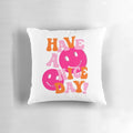 A soft, plush decorative pillow featuring a retro smiley face design in shades of pink and orange, perfect for a preppy, positive aesthetic.