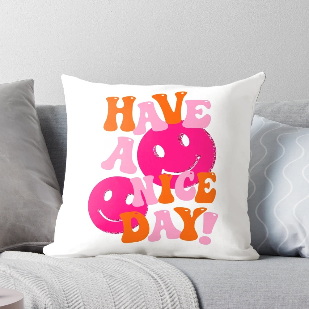 A soft, plush decorative pillow featuring a retro smiley face design in shades of pink and orange, perfect for a preppy, positive aesthetic.