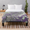 Purple and sage plush blanket with abstract zigzag and swirl pattern