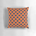 Decorative quatrefoil patterned pillow in navy blue and orange
