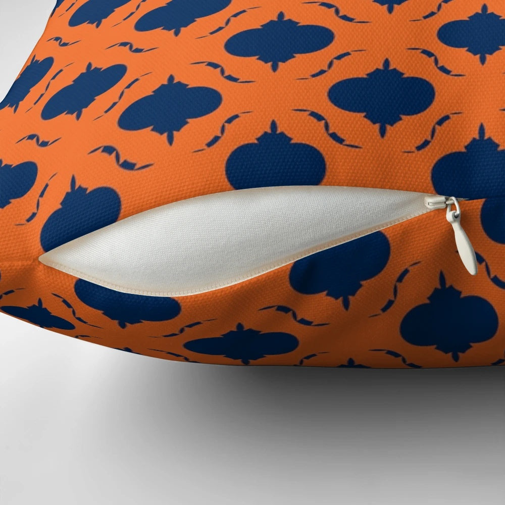 Decorative quatrefoil patterned pillow in navy blue and orange