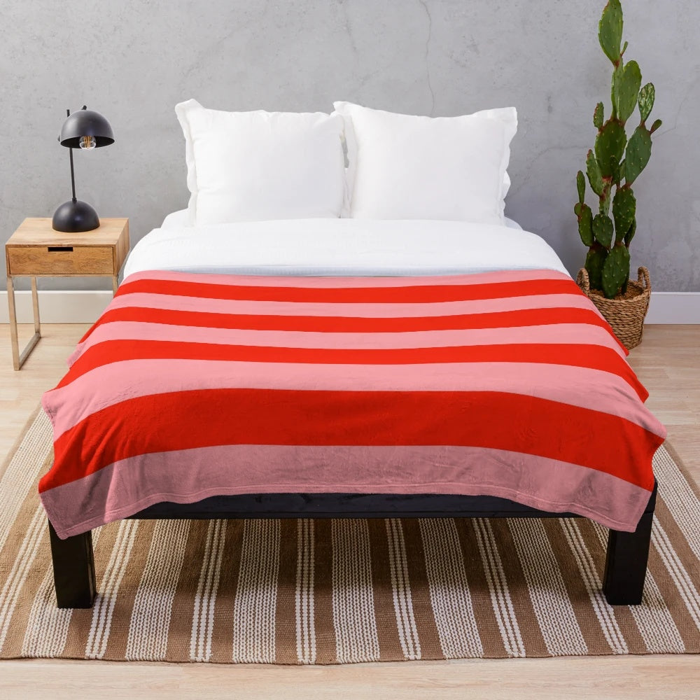 Soft, cozy red and pink striped plush blanket