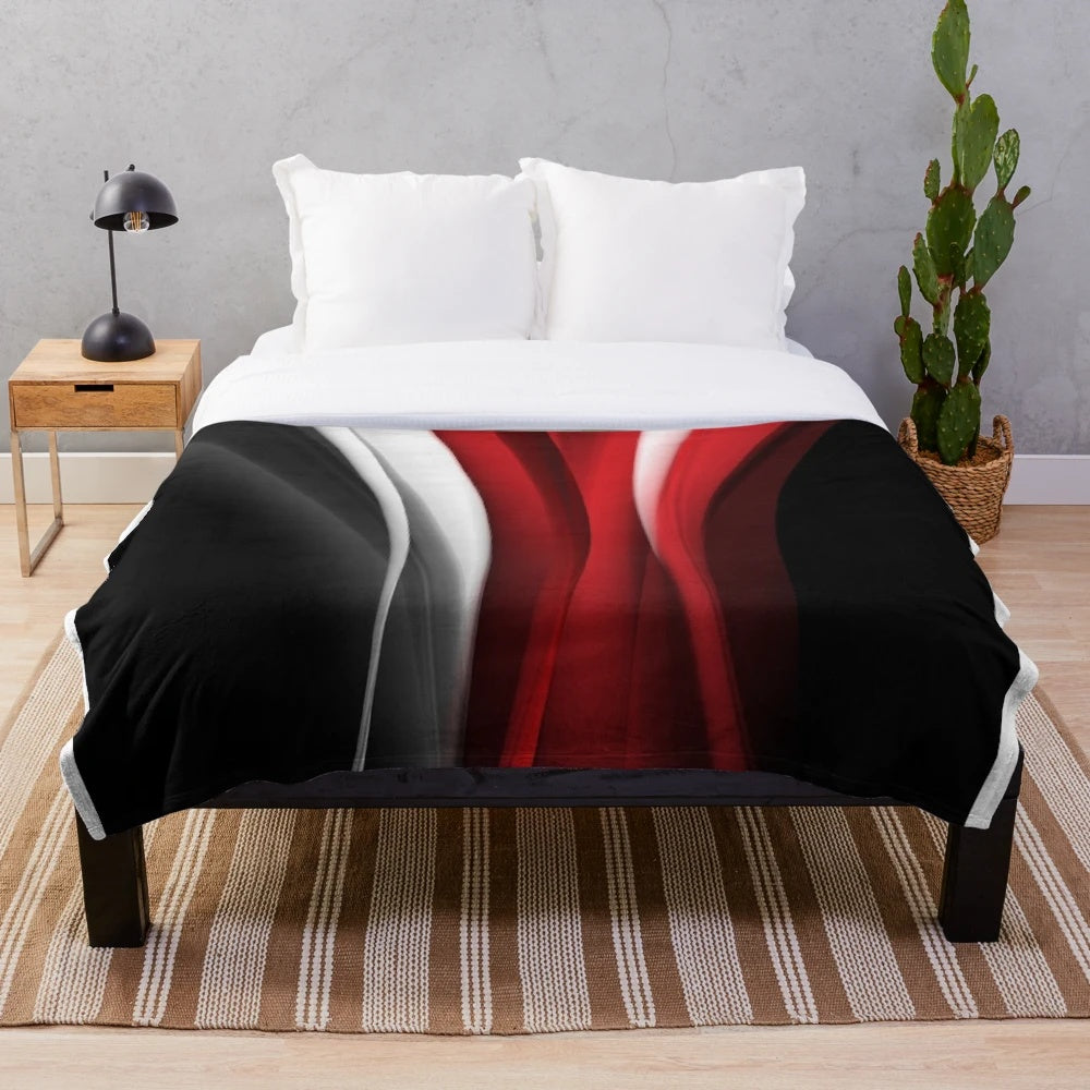 Red and white plush blanket with abstract pattern design