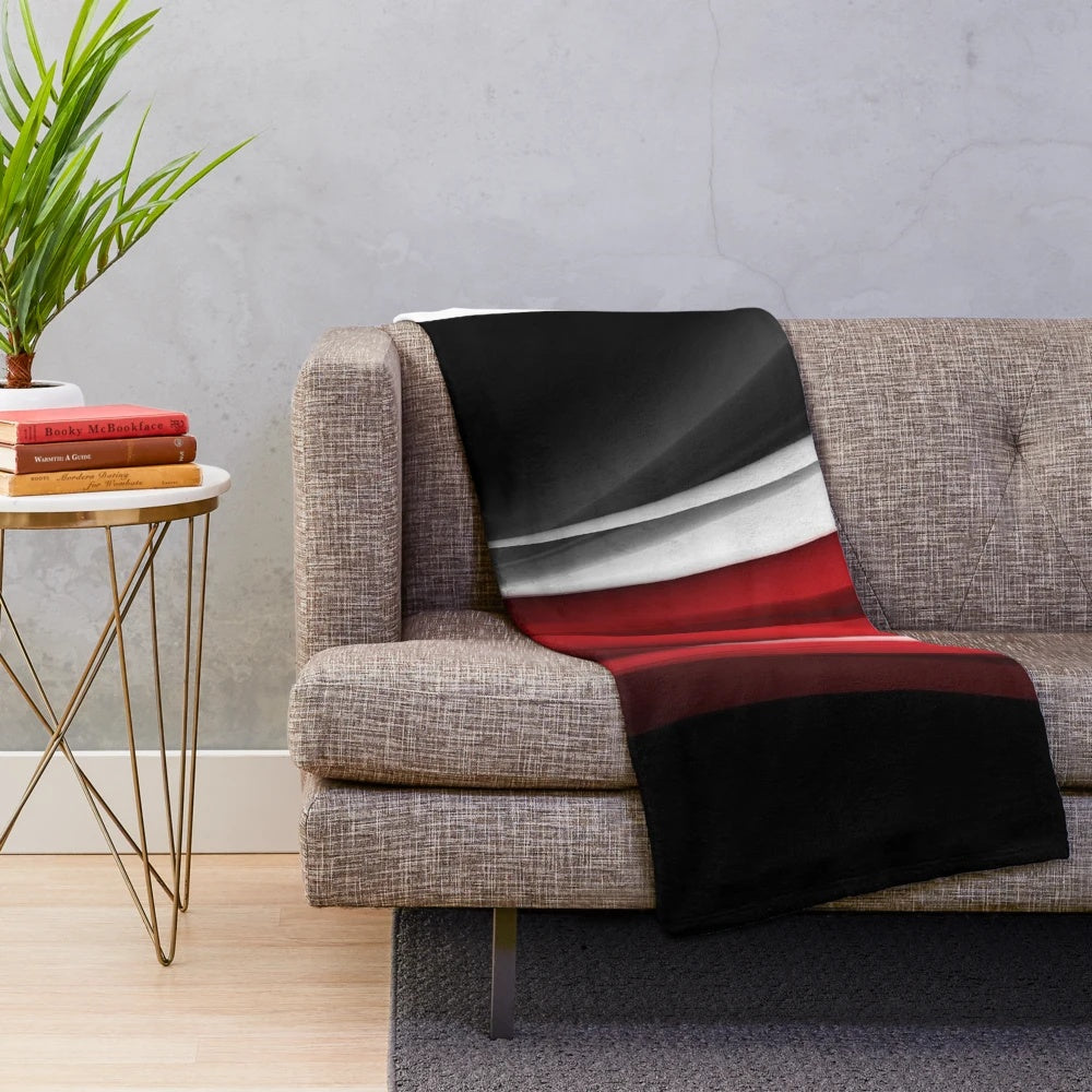 Red and white plush blanket with abstract pattern design