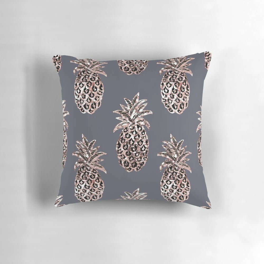 Rose gold and glitter pineapple design on a gray pillow