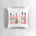 Rose-themed decorative pillow with bottles and wine glasses on a white background