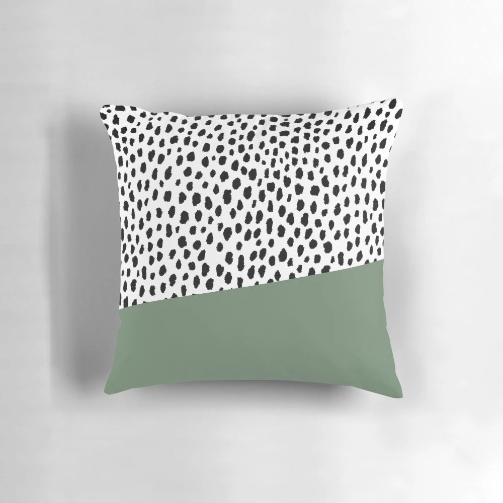 Decorative accent pillow featuring a bold dalmatian spots print in shades of sage green, black, and white.