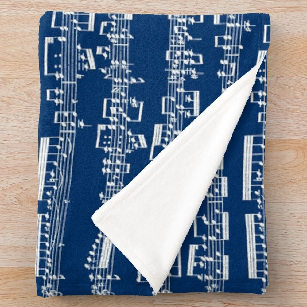 Plush blanket featuring a minimalist black and white sheet music design
