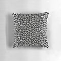 Snow leopard print pillow with a chic, spotted pattern