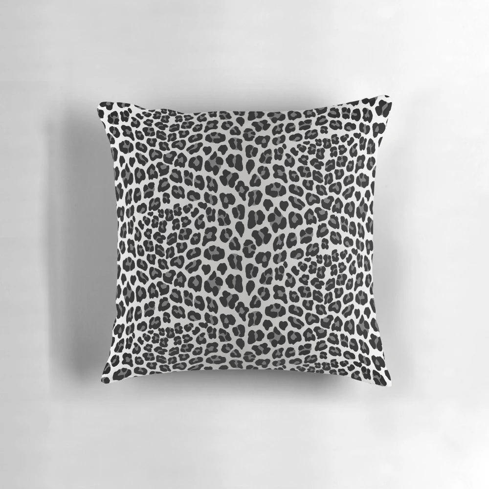 Snow leopard print pillow with a chic, spotted pattern