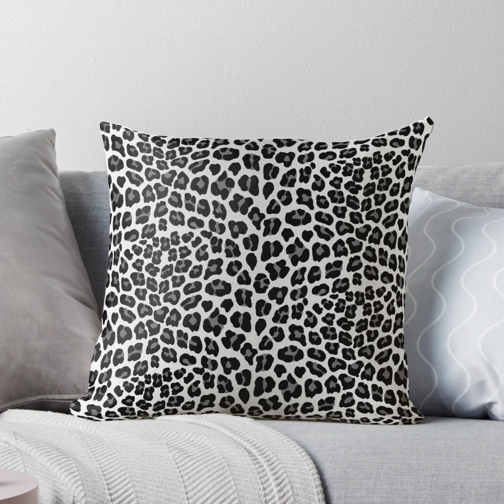 Snow leopard print pillow with a chic, spotted pattern