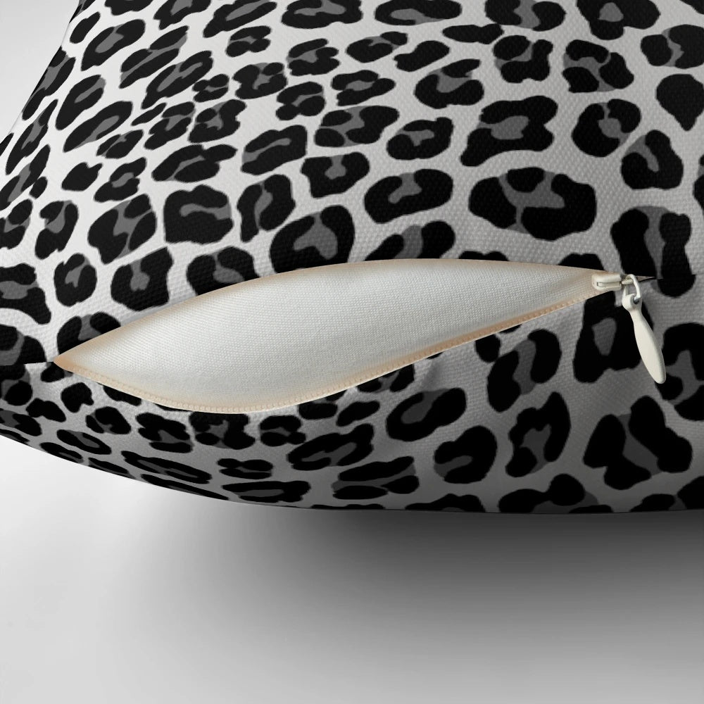 Snow leopard print pillow with a chic, spotted pattern