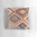 Southwestern-inspired throw pillow with a distressed tribal rug pattern in rust and red tones