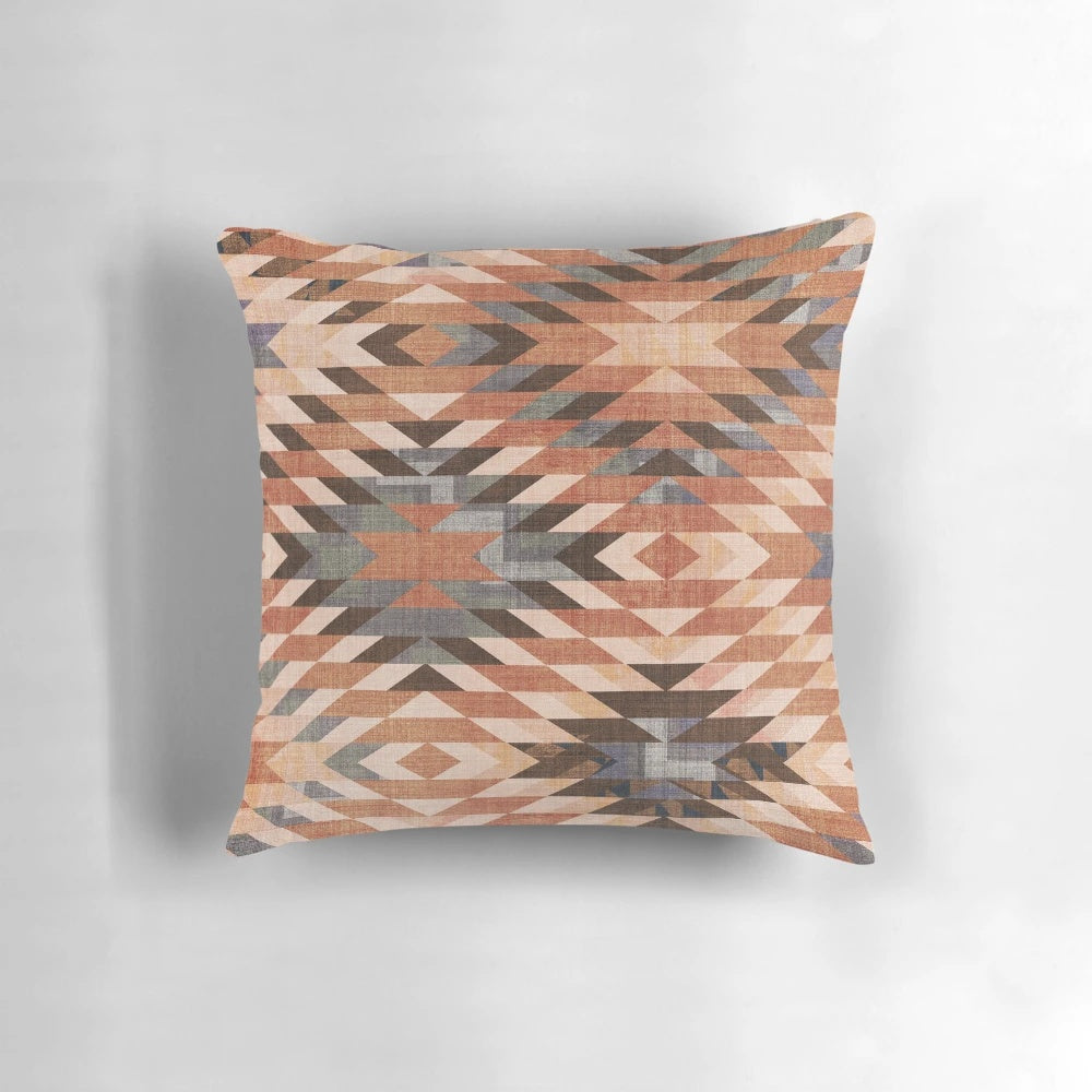 Southwestern-inspired throw pillow with a distressed tribal rug pattern in rust and red tones