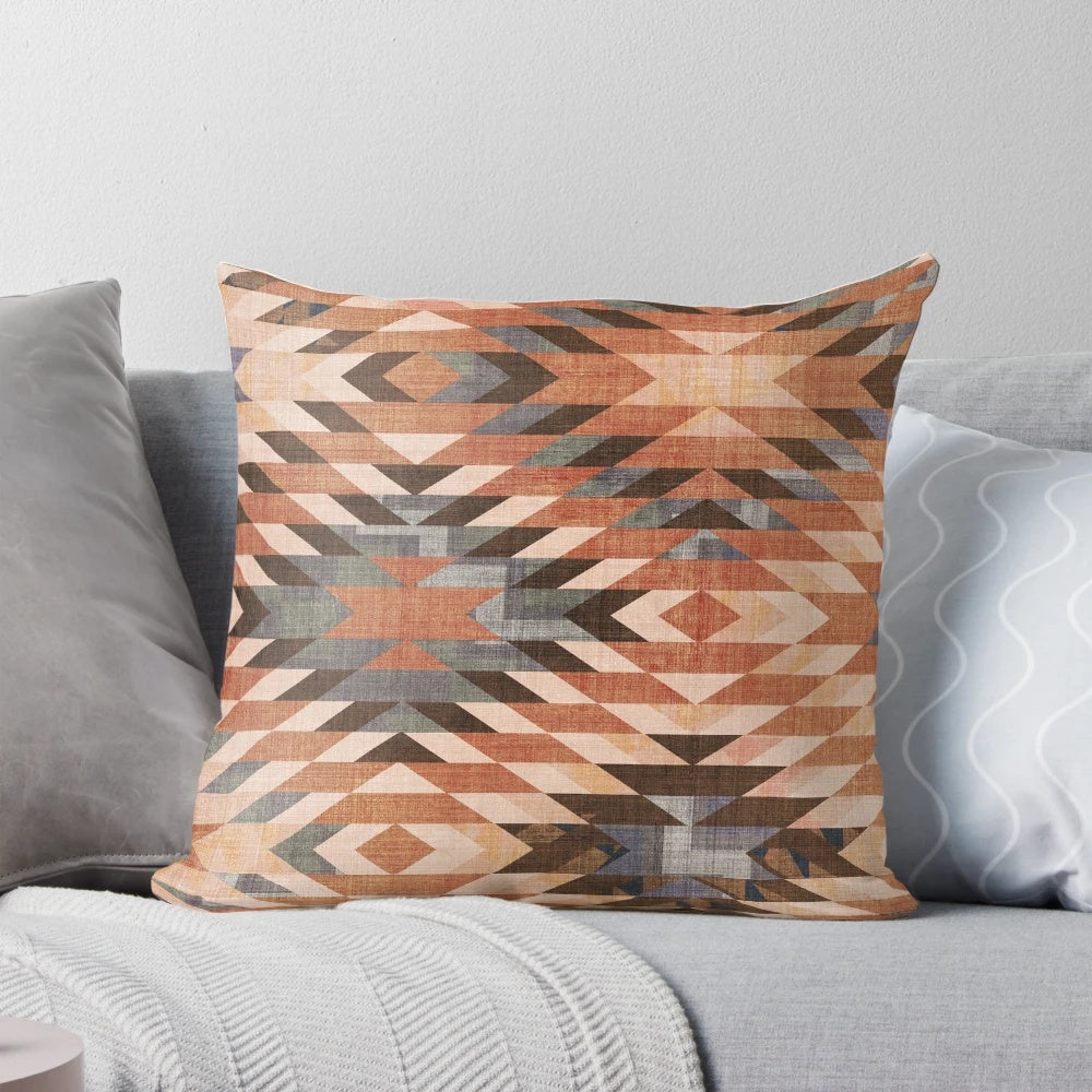 Southwestern-inspired throw pillow with a distressed tribal rug pattern in rust and red tones