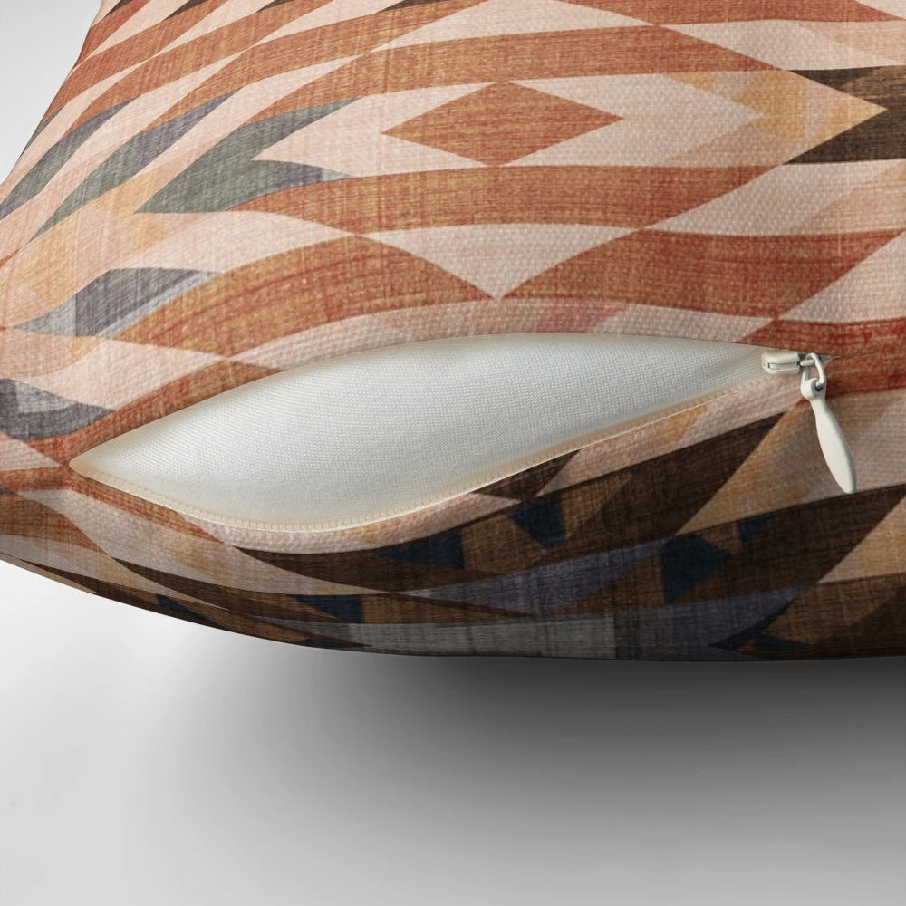 Southwestern-inspired throw pillow with a distressed tribal rug pattern in rust and red tones