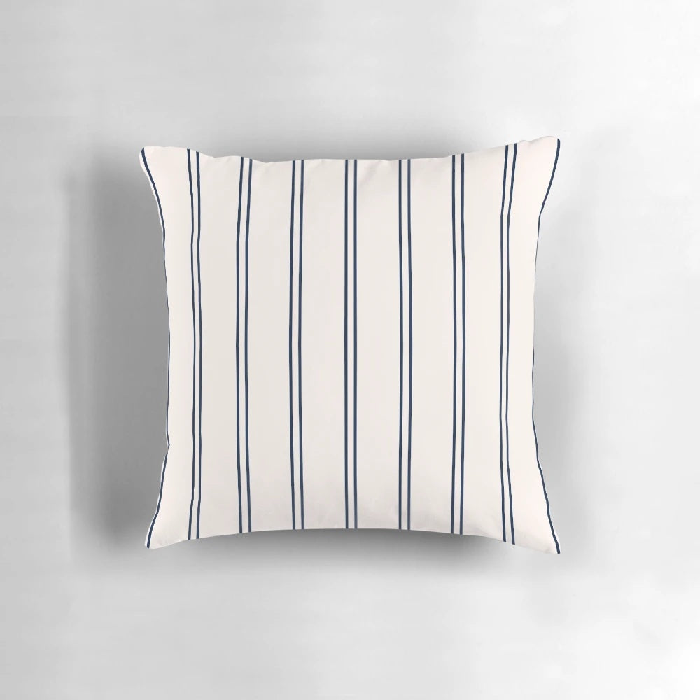 Striped navy blue and white pillow with a minimalist design