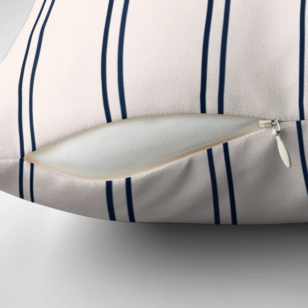 Striped navy blue and white pillow with a minimalist design