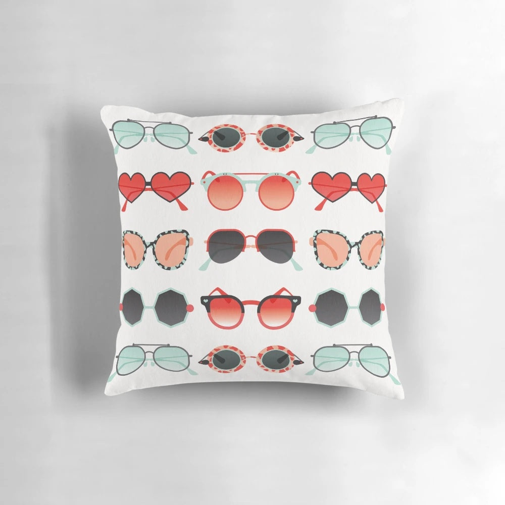 Red and mint colored decorative throw pillow with a sunglasses illustration design