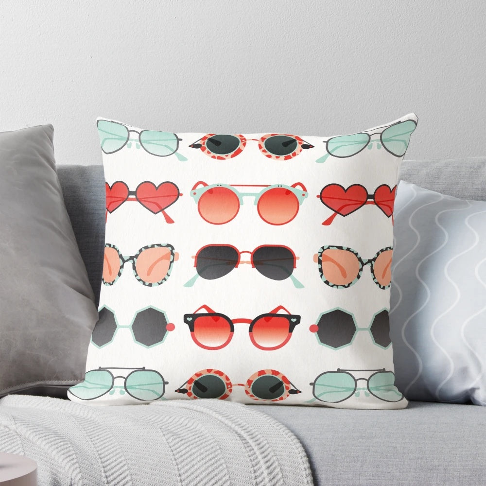 Red and mint colored decorative throw pillow with a sunglasses illustration design