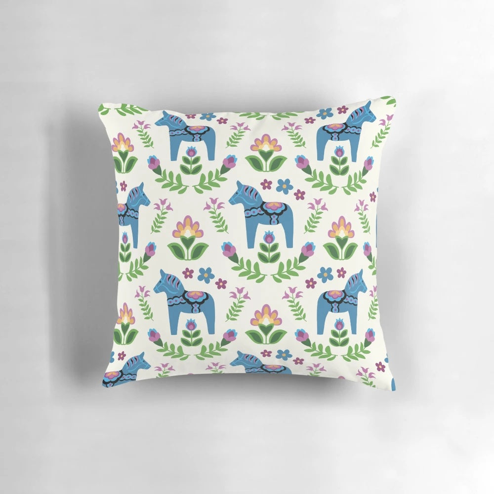 A vibrant blue Dala horse pillow, a classic symbol of Swedish folk art and Scandinavian design.