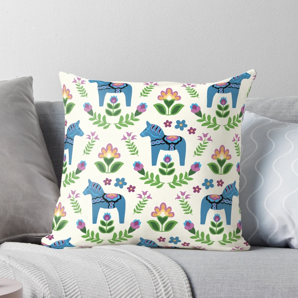 A vibrant blue Dala horse pillow, a classic symbol of Swedish folk art and Scandinavian design.
