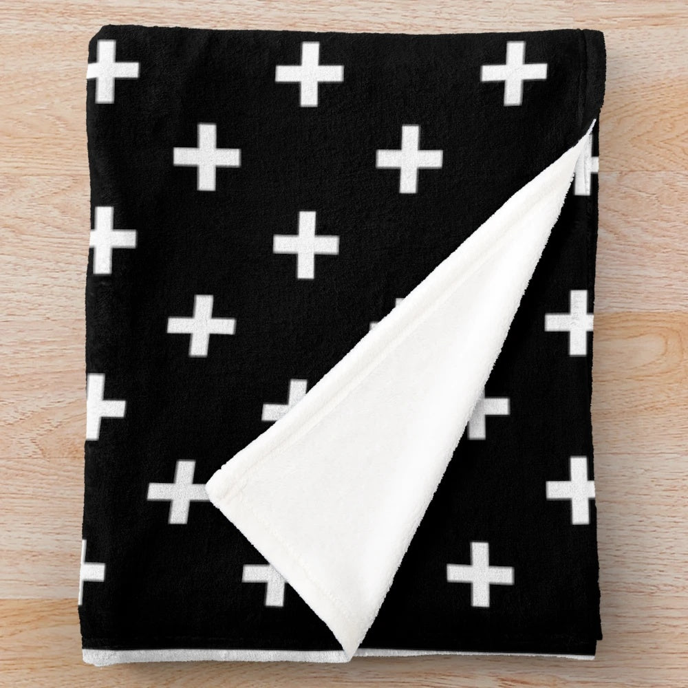 Swiss Cross patterned plush blanket in black and white for modern, minimalist home decor