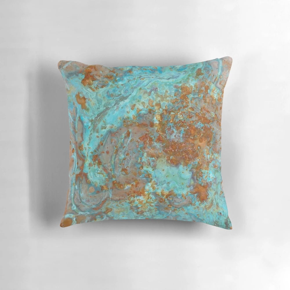Teal and copper-colored decorative pillow with a marble-like effect, perfect for modern home decor.