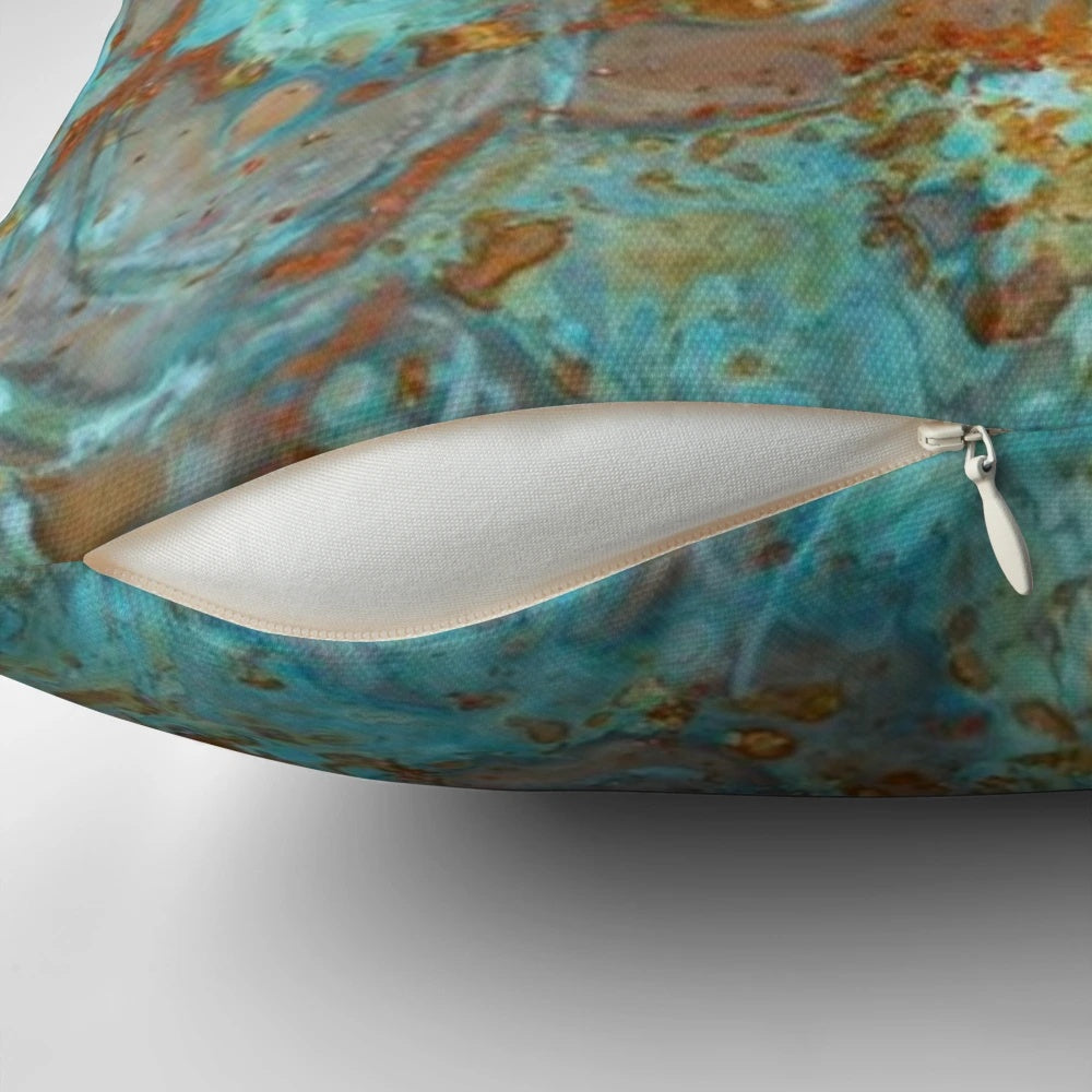 Teal and copper-colored decorative pillow with a marble-like effect, perfect for modern home decor.