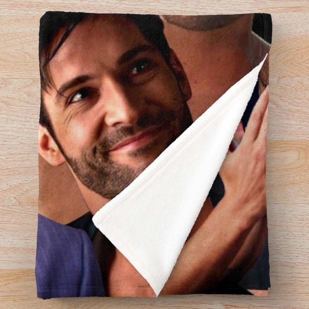Cozy plush blanket featuring a photo collage of British actor Tom Ellis, best known for his role as Lucifer on the Netflix series.