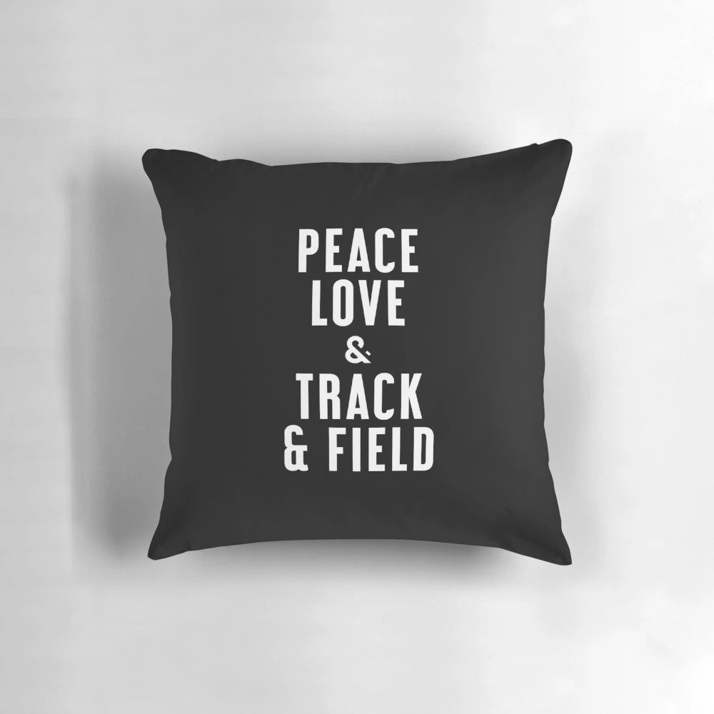 A navy blue pillow with a white graphic design featuring the words "Peace Love and Track & Field