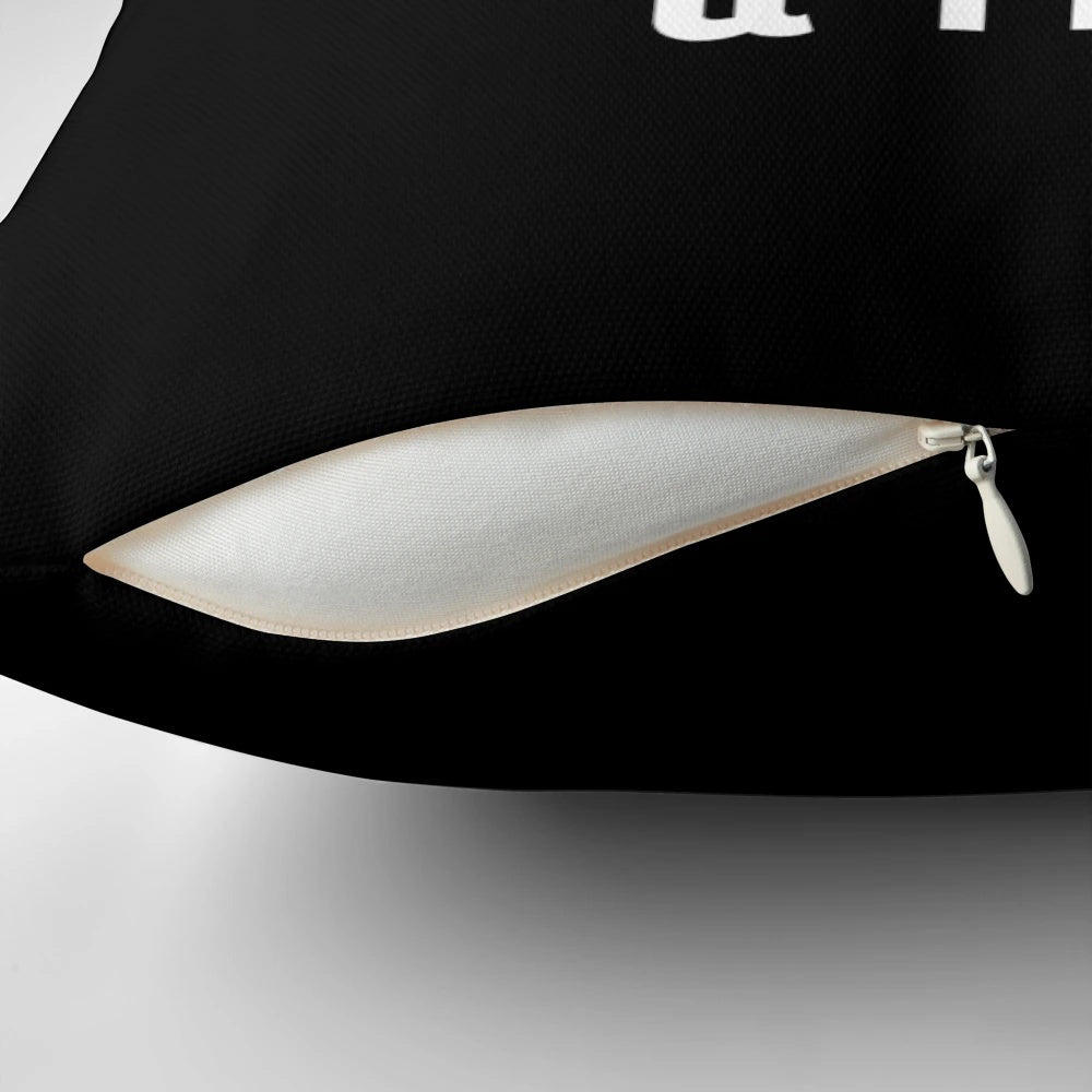 A navy blue pillow with a white graphic design featuring the words "Peace Love and Track & Field