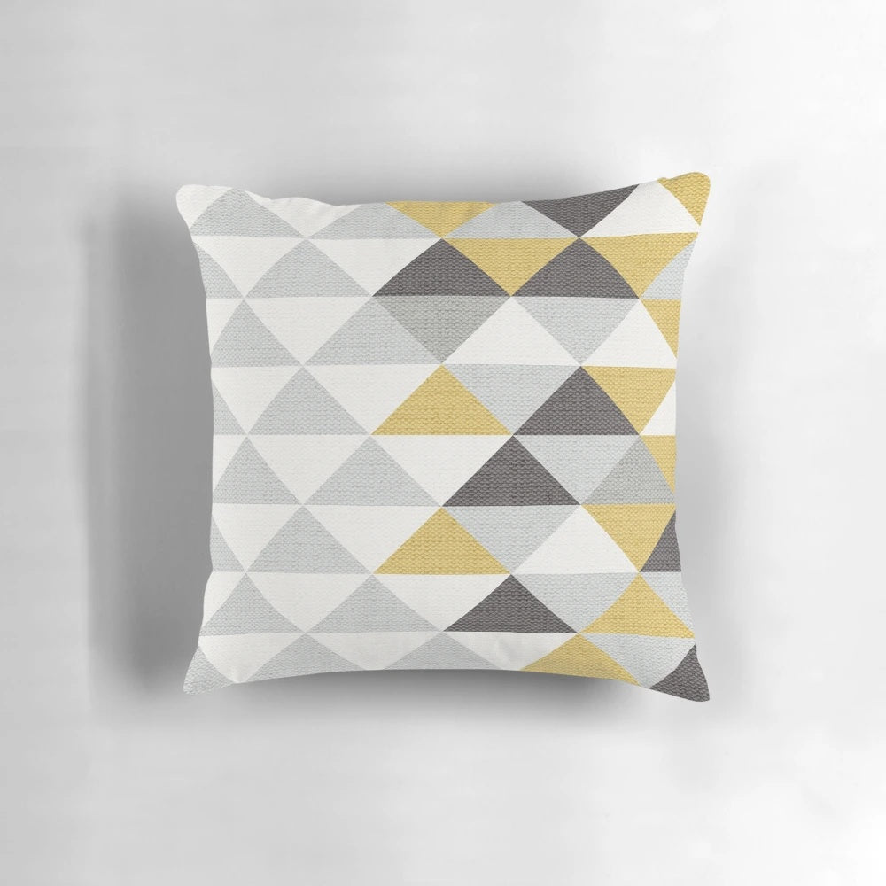 A navy, gray, cream, and yellow triangle pattern textured pillow for modern home decor.
