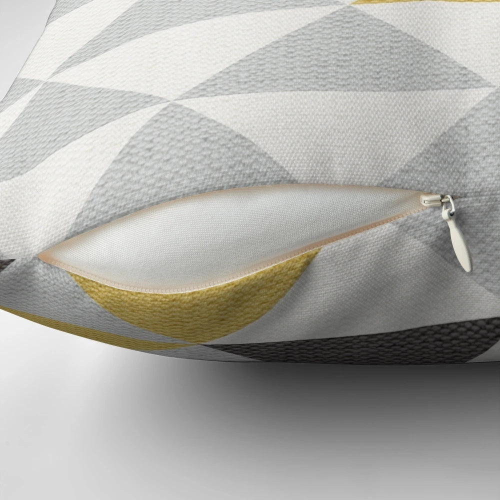 A navy, gray, cream, and yellow triangle pattern textured pillow for modern home decor.