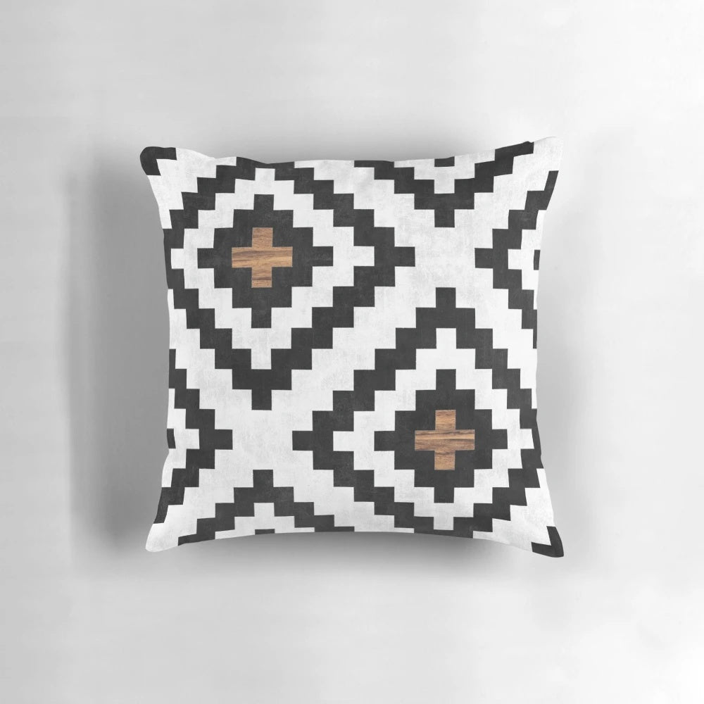 Tribal pattern pillow with concrete and wood accents, perfect for boho-inspired home decor