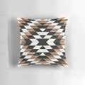 Pillow featuring a tribal-inspired abstract pattern in shades of gray, with concrete and wood accents.