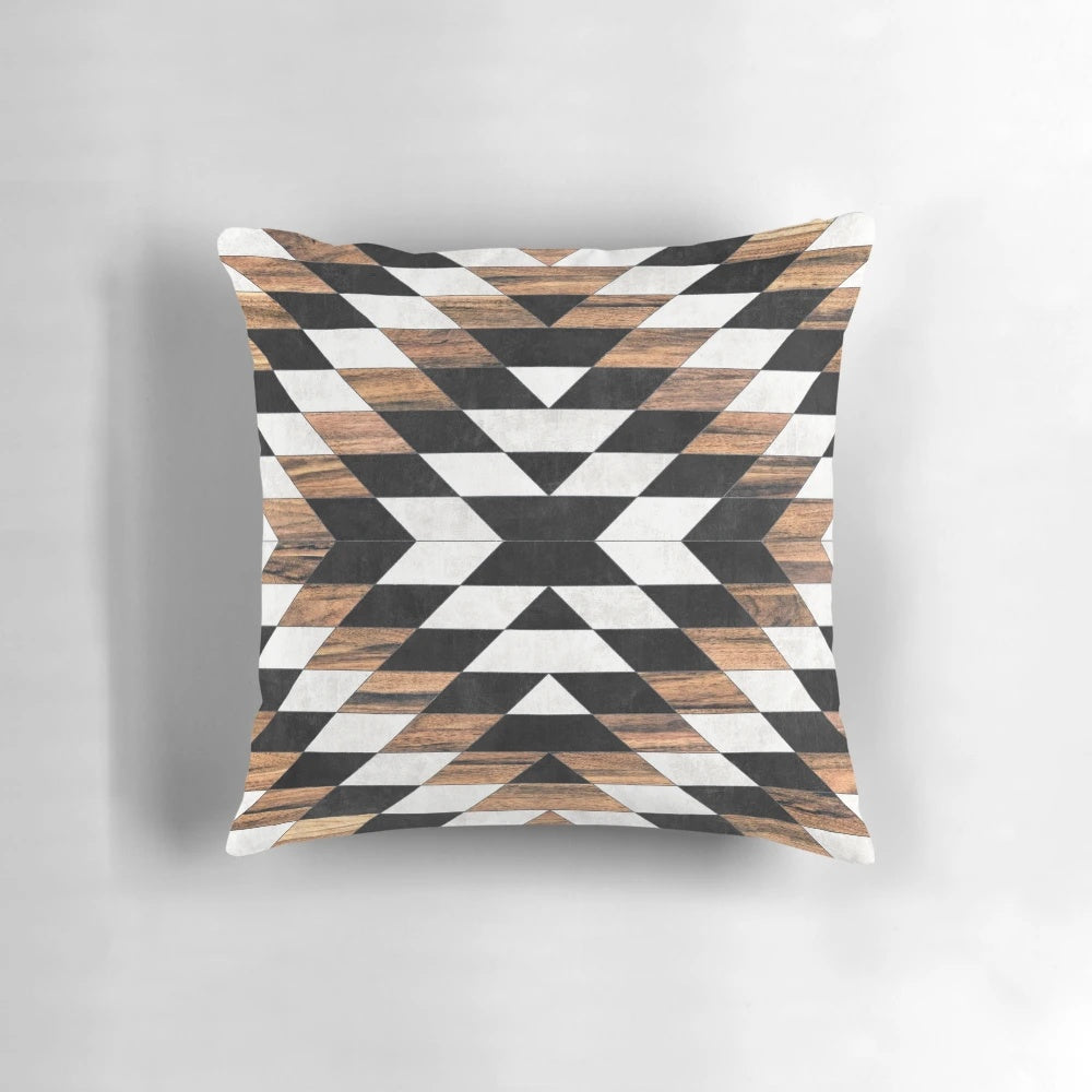 Pillow featuring a tribal-inspired abstract pattern in shades of gray, with concrete and wood accents.
