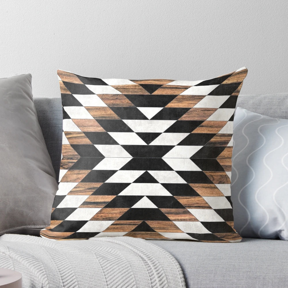 Pillow featuring a tribal-inspired abstract pattern in shades of gray, with concrete and wood accents.
