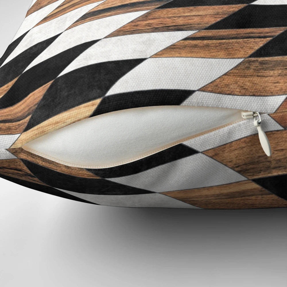 Pillow featuring a tribal-inspired abstract pattern in shades of gray, with concrete and wood accents.