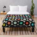 Soft and cozy vinyl plush blanket with a retro polka dot pattern, perfect for music and pop culture enthusiasts.
