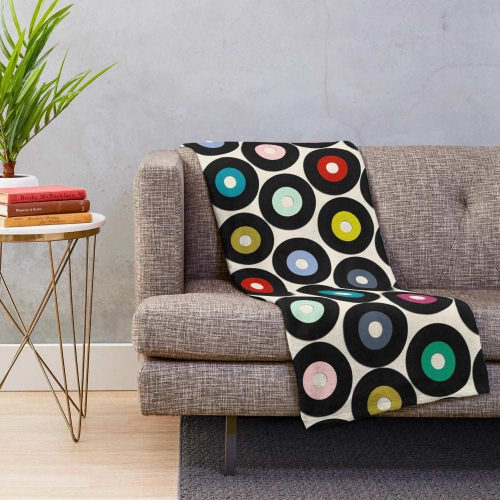 Soft and cozy vinyl plush blanket with a retro polka dot pattern, perfect for music and pop culture enthusiasts.