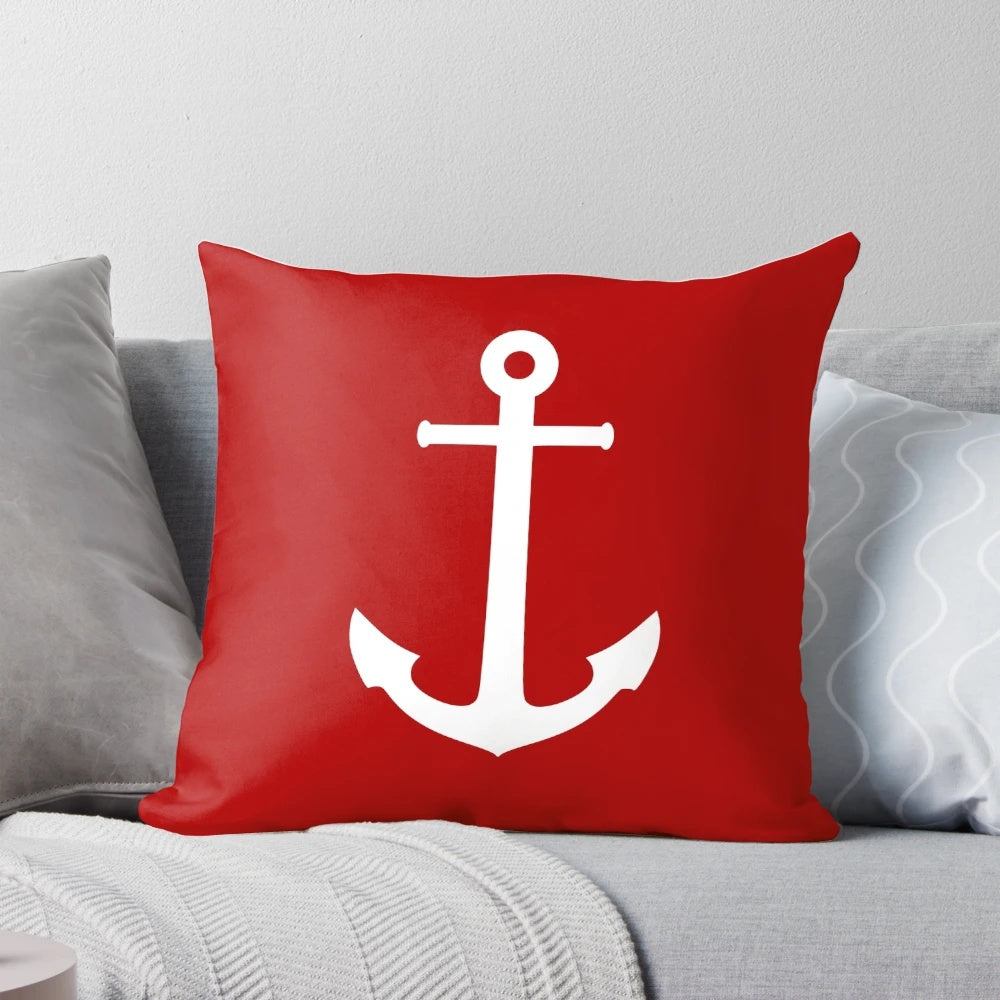 White anchor design on a medium red pillow, perfect for nautical and coastal home decor.