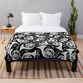 White plush blanket featuring a pattern of french horns and music notes
