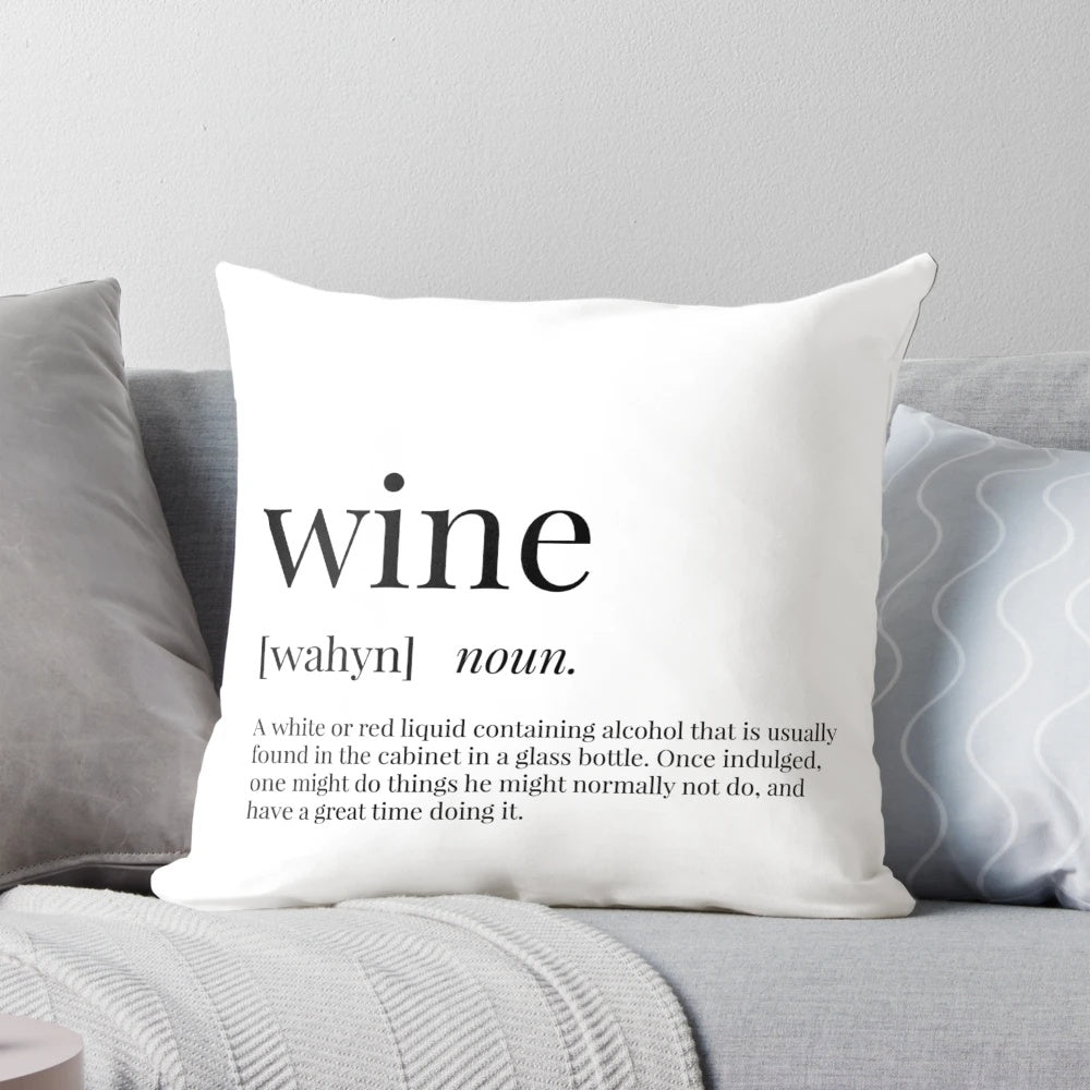 A cozy, decorative wine definition throw pillow showcasing the word "wine" in a typographic design.