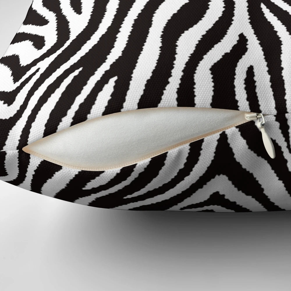 Decorative throw pillow featuring a striking black and white zebra pattern design