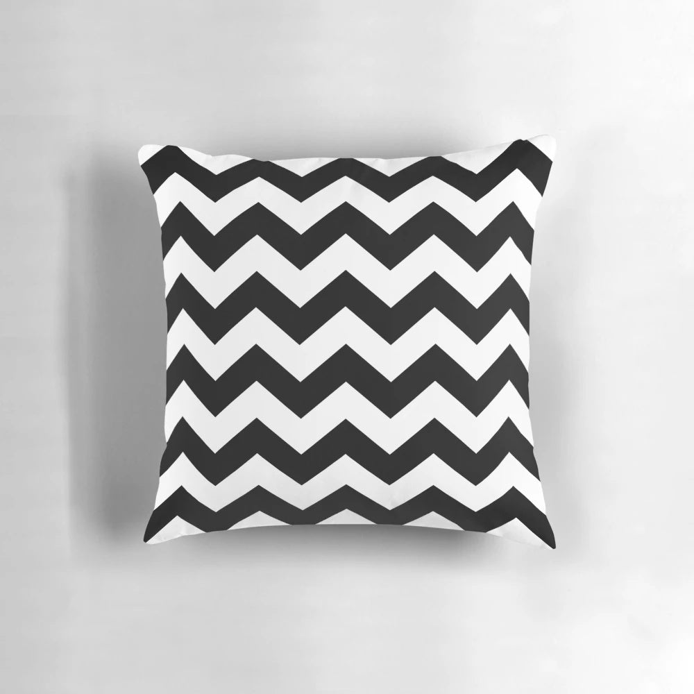 Black and white zig zag pattern throw pillow with a contemporary, minimalist design.