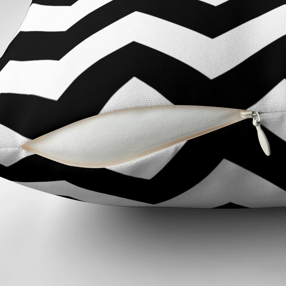 Black and white zig zag pattern throw pillow with a contemporary, minimalist design.